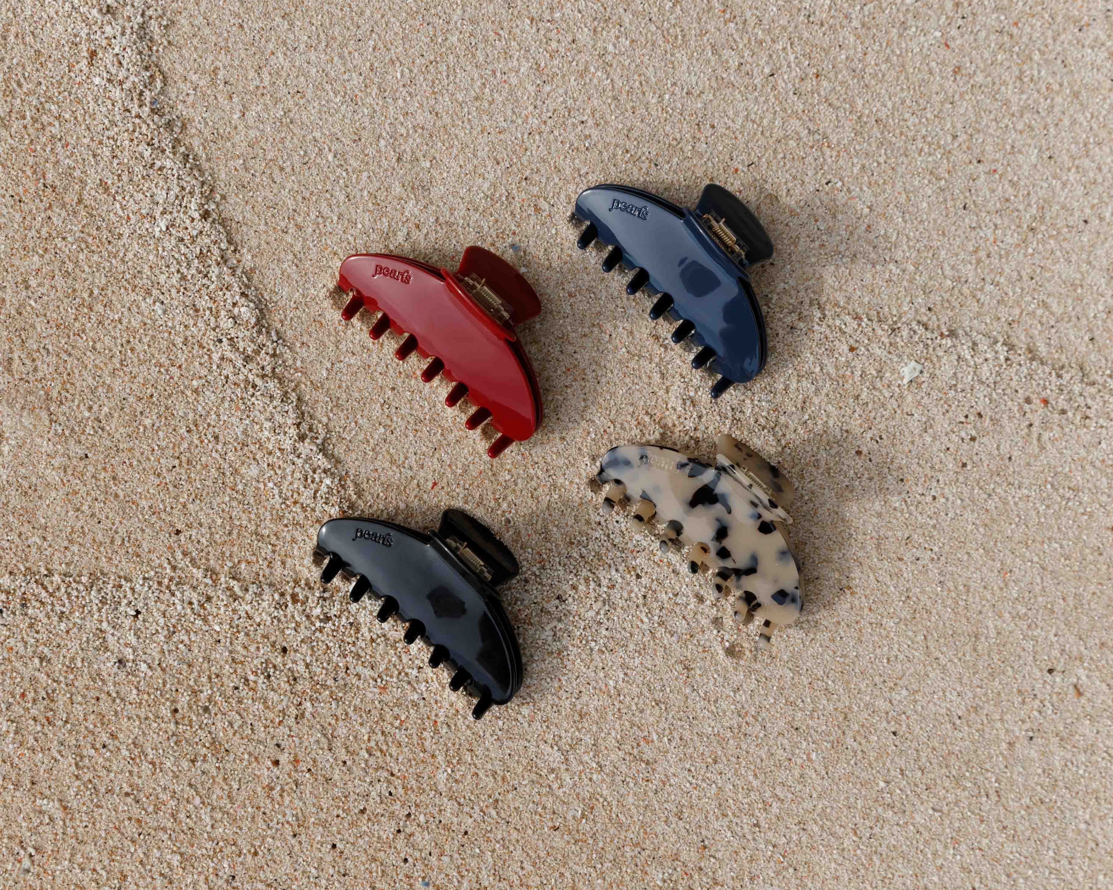 Four Pearls Studios claw clips on the sand