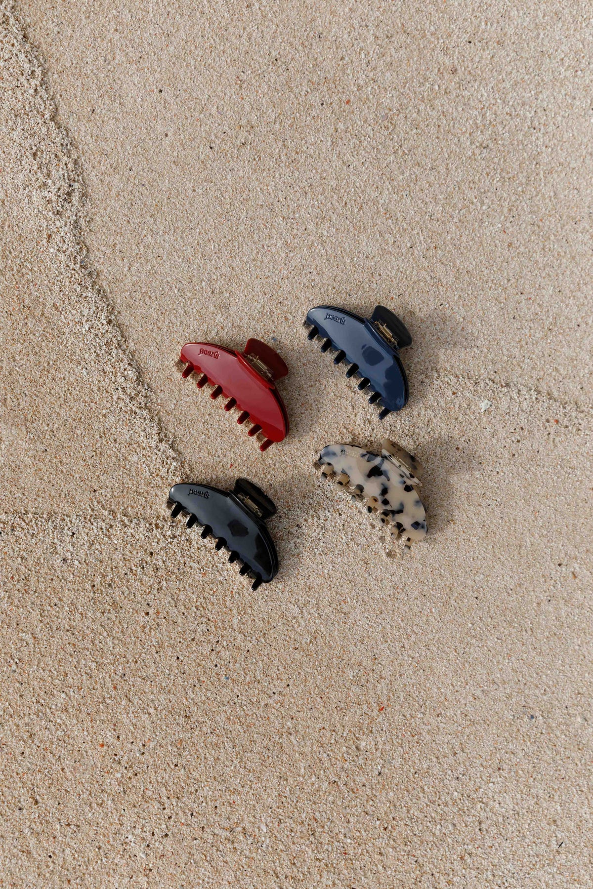 Four Pearls Studios claw clips on the sand