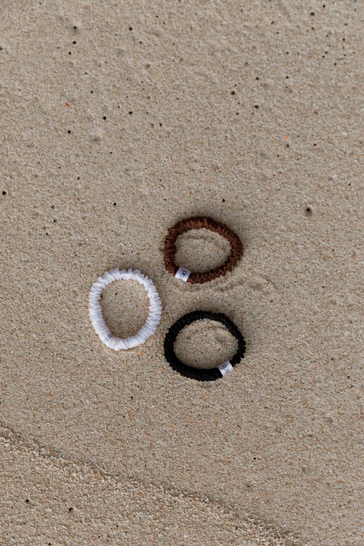 Silk scrunchies by Pearls Studios on the sand